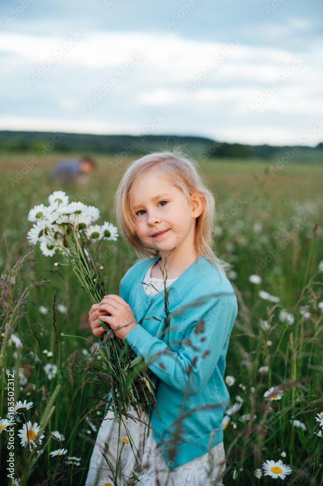 Little girl in a chamomile field Little girl in a chamomile field