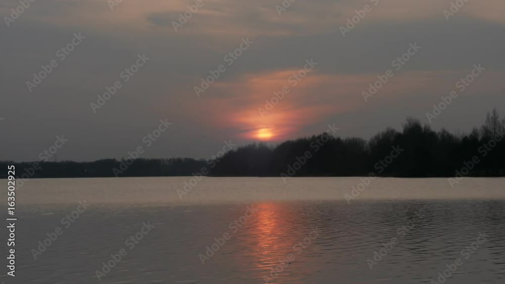 Sunset over the lake, sun reflection in time-lapse,Sunset at time-lapse Sunset over the lake, sun reflection in time-lapse,Sunset at time-lapse