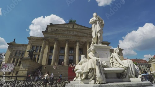Time Lapse At Gendarmenmarkt In Berlin. Schiller Statue In Front Of Classical Concert Hall