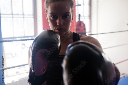 Portrait of confident woman practicing boxing © wavebreak3