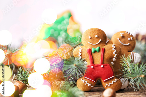 Composition of tasty Christmas cookies and natural decor on wooden table