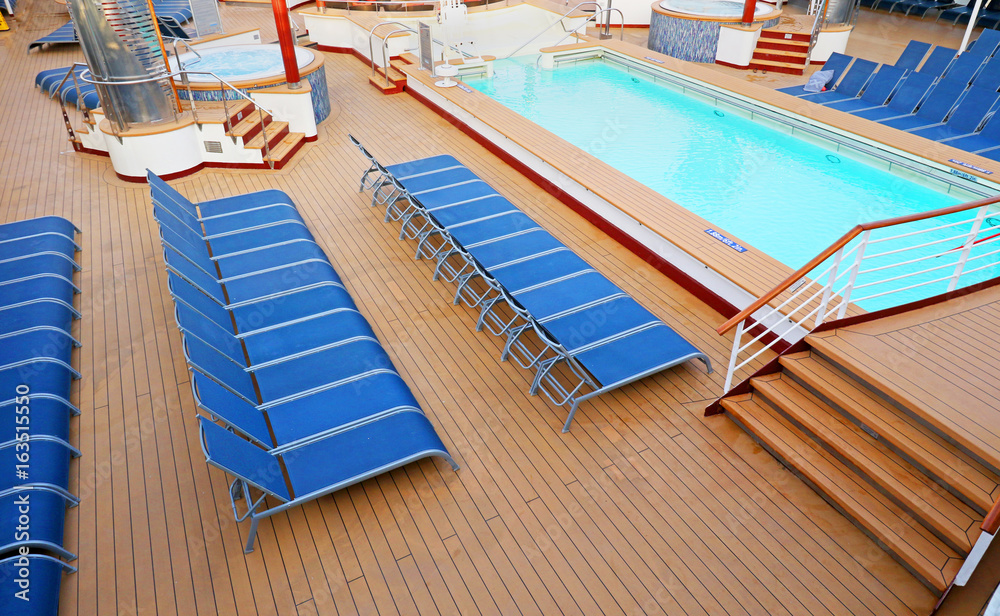 Fototapeta premium Blue Deck Chairs neatly placed on a Ship Deck