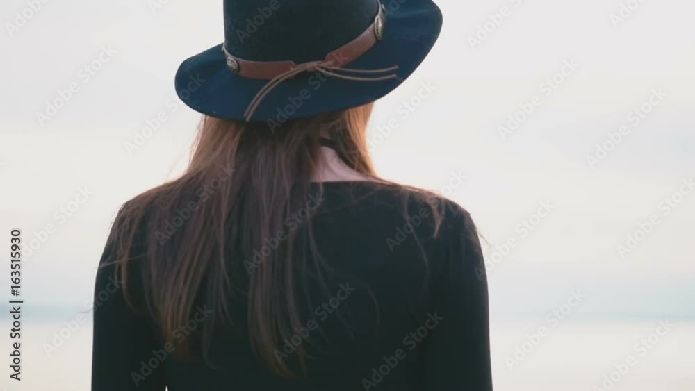 Girl is walking along the beach slow motion Girl is walking along the beach slow motion