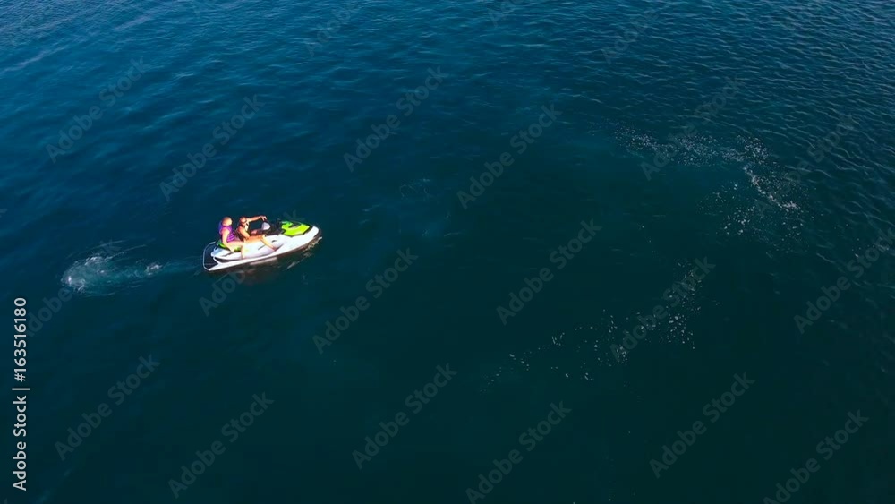 Scooter accelerates extremely fast on water aerial view 4K Scooter accelerates extremely fast on water aerial view 4K