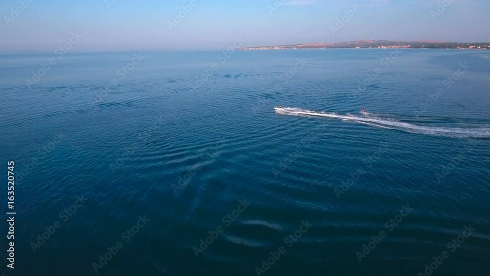 Overflight of wakeboarder and scooter on sea 4K Overflight of wakeboarder and scooter on sea 4K