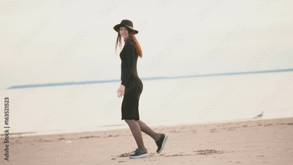 Girl is spinning on one foot on the beach slow motion Girl is spinning on one foot on the beach slow motion