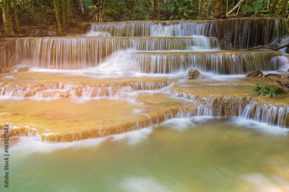 Fototapeta premium Natural multiple layers stream waterfall in tropical national park of Thailand, natural landscape background