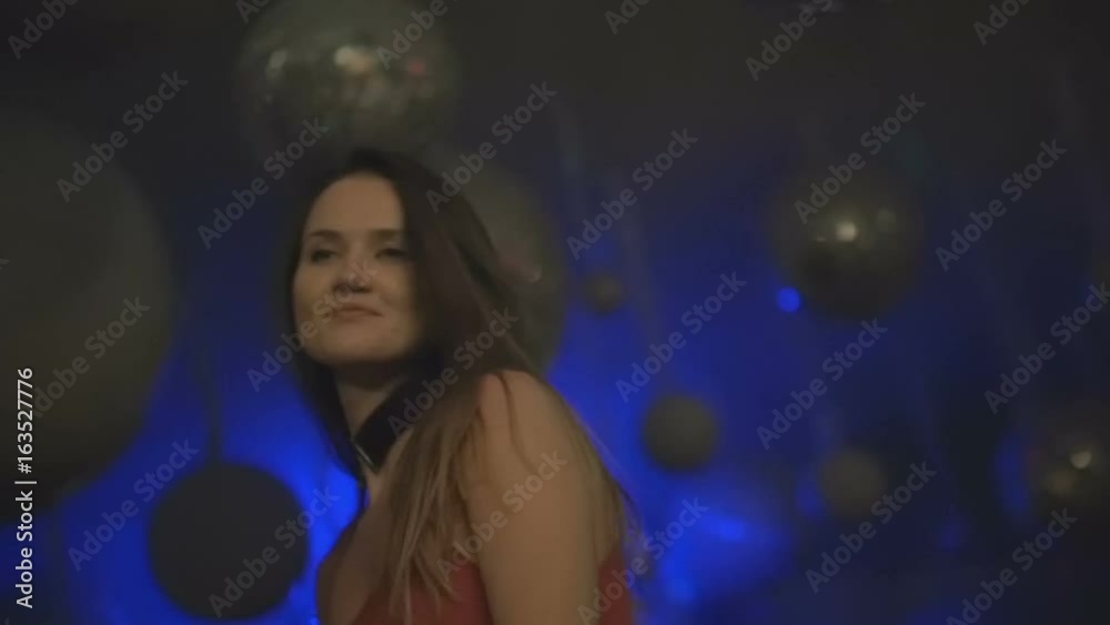 Girl in a red dress is dancing at a party close up slow motion Girl in a red dress is dancing at a party close up slow motion