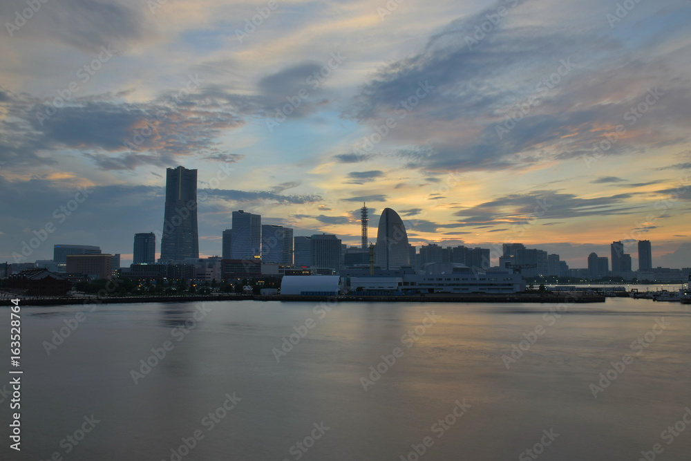 Urban Landscape of Yokohama, Japan with moving colorful clouds in horizontal frame