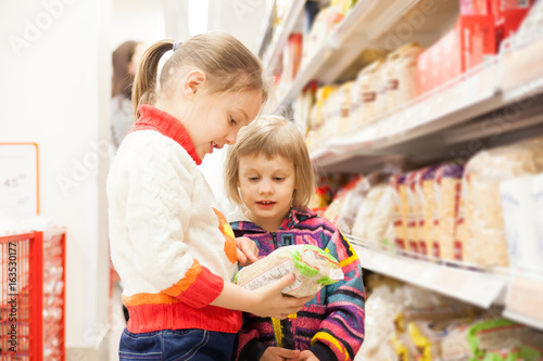 children in store at shelves with products.