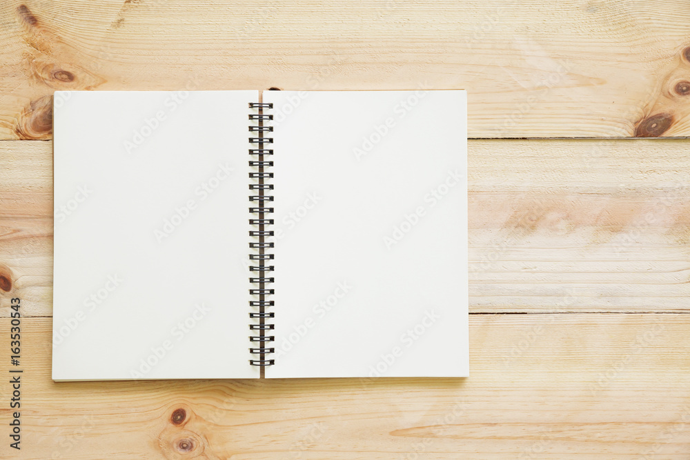 Open book on textured wood background. Open book on textured wood background.