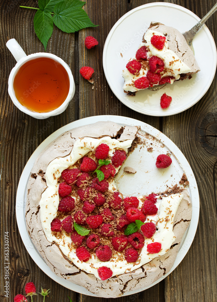 Chocolate dessert (pie) of pavlov with cream and raspberries. Chocolate dessert (pie) of pavlov with cream and raspberries.