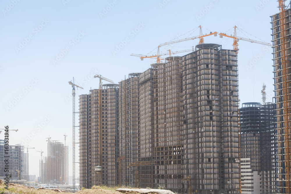 Cranes building a block