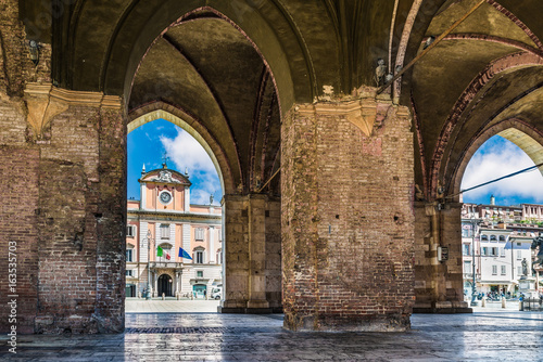 Piacenza, medieval town, Italy. Piazza Cavalli (Square horses) and Palazzo del Governatore  (Governor's palace) from the arcade of palazzo Gotico (Gothic palace) in the city center photo