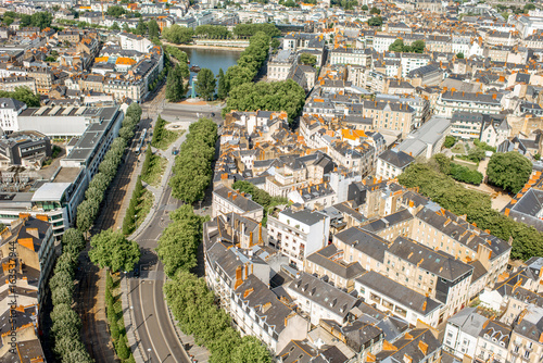 Aerial cityscape view with beautiful buildings and wide avenue in Nantes city during the sunny weather in France