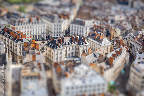 Aerial cityscape view with beautiful old buildings in Nantes city during the sunny weather in France. Tilt shift image technic