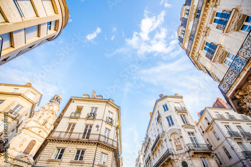 Street view from below on the beautiful buildings and blue sky in Nantes city in France