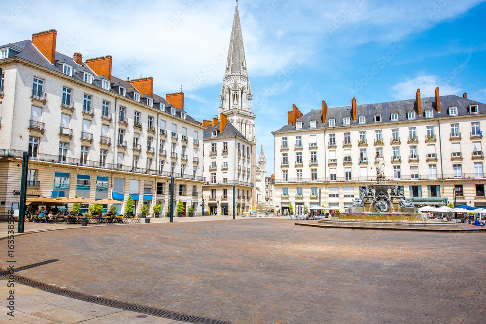 View on the Royal square with fountain and church tower in Nantes city in France