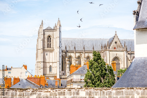 City scape view on the beautiful saint Pierre cathedral with birds flying in Nantes city in France photo