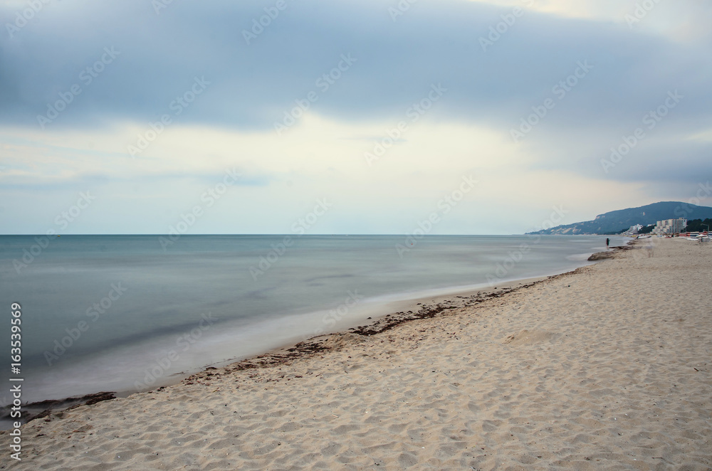 Obraz premium The Black Sea shore from Albena, Bulgaria with golden sands, sun, blue mystic water, umbrellas and sunbeds