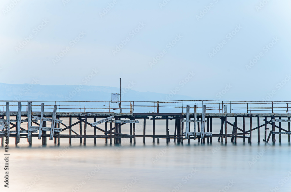 Old bridge over the mystical blue sea water, The Black Sea shore coastline seaside