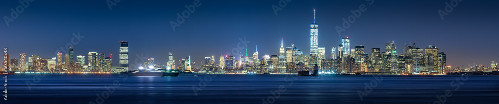 New York City Financial District skyscrapers and Hudson River at dusk. Panoramic view of Lower Manhattan