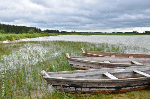 Old rustic wooden fishing boats on the lake at stormy weather  close up