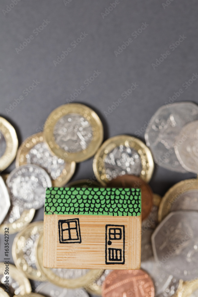 House model with british coins. Home finance concept House model with british coins. Home finance concept