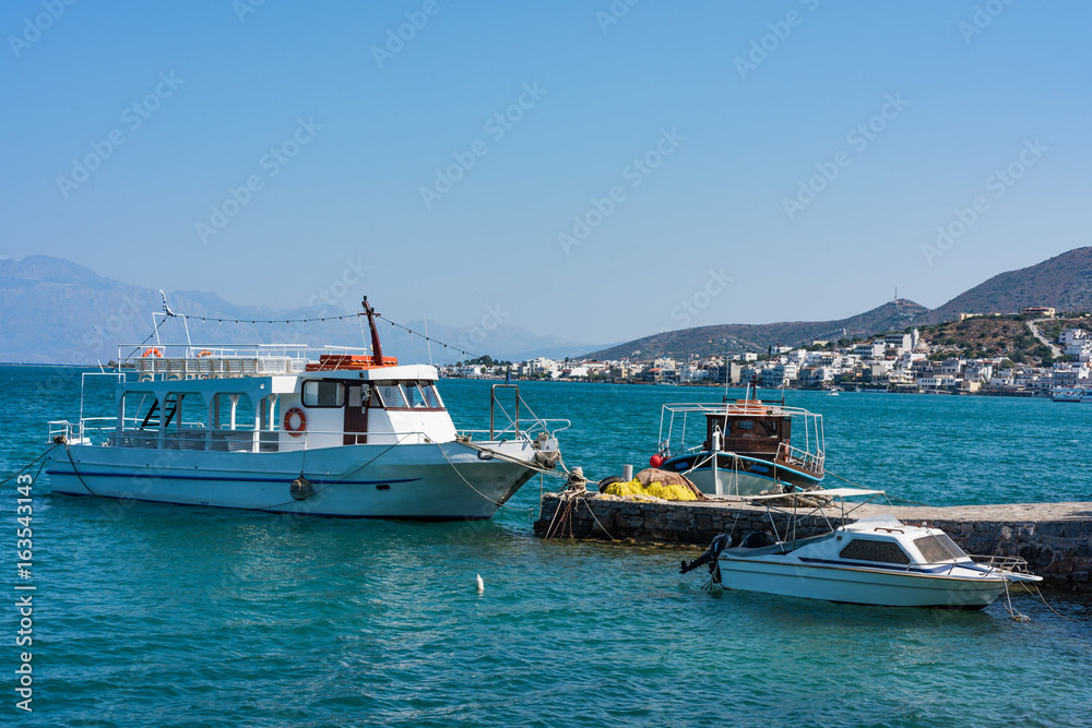 Boats in a blue sea, Elounda coast of Crete island in Greece