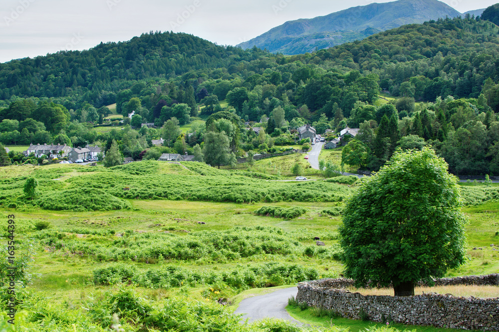 Lake District National Park, England, view of the road, town, mountains on the background, selective focus