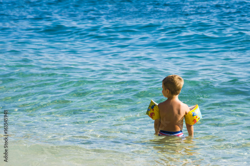 Happy kid swimming photo