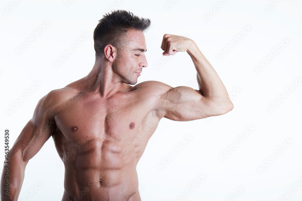 Handsome muscular fit young man on studio background Handsome muscular fit young man on studio background