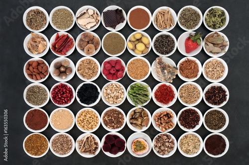 Aphrodisiac food sampler of foods to promote sexual health in china bowls on slate background.