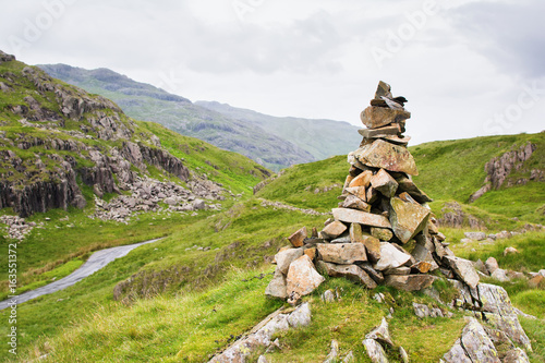 Views in Lake District National Park, England, built stone formation, mountains on the background, selective focus © Liliya Trott