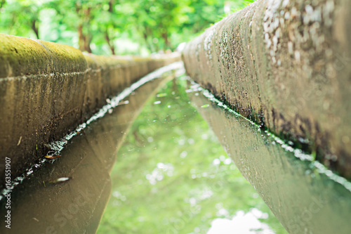 water flows down through the trough photo