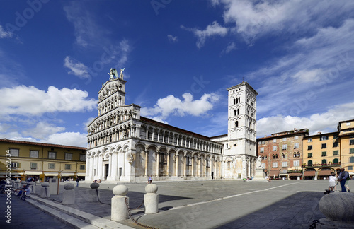 Lucca, Italy - church San Michele in Foro with sculpure of Holy Michel on Top and monument for citizen Francesco Burlamacchi photo