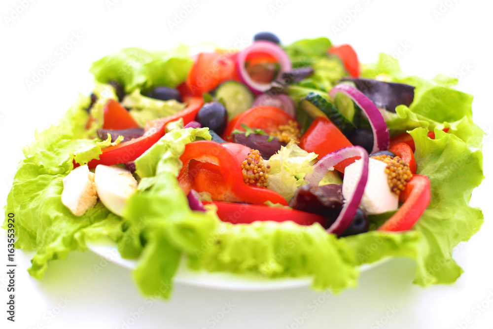 salad from fresh vegetables in a plate on a table, selective focus salad from fresh vegetables in a plate on a table, selective focus