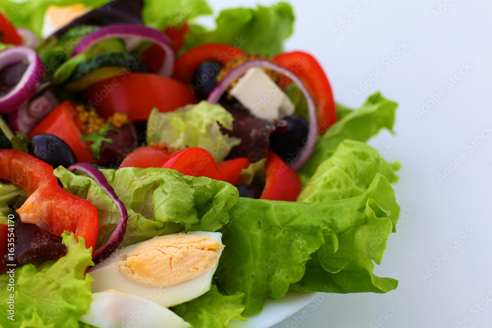 salad from fresh vegetables in a plate on a table, selective focus salad from fresh vegetables in a plate on a table, selective focus