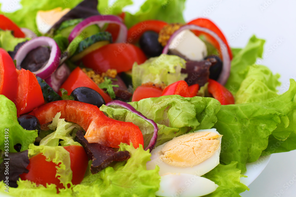 salad from fresh vegetables in a plate on a table, selective focus salad from fresh vegetables in a plate on a table, selective focus