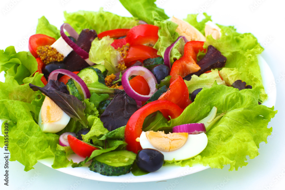 salad from fresh vegetables in a plate on a table, selective focus salad from fresh vegetables in a plate on a table, selective focus