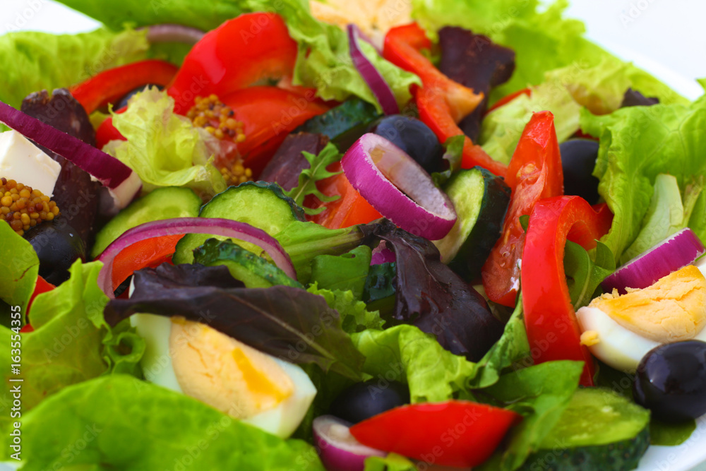 salad from fresh vegetables in a plate on a table, selective focus salad from fresh vegetables in a plate on a table, selective focus