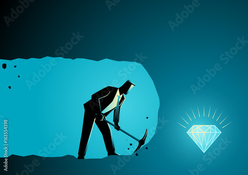 Businessman digging and mining to find treasure photo