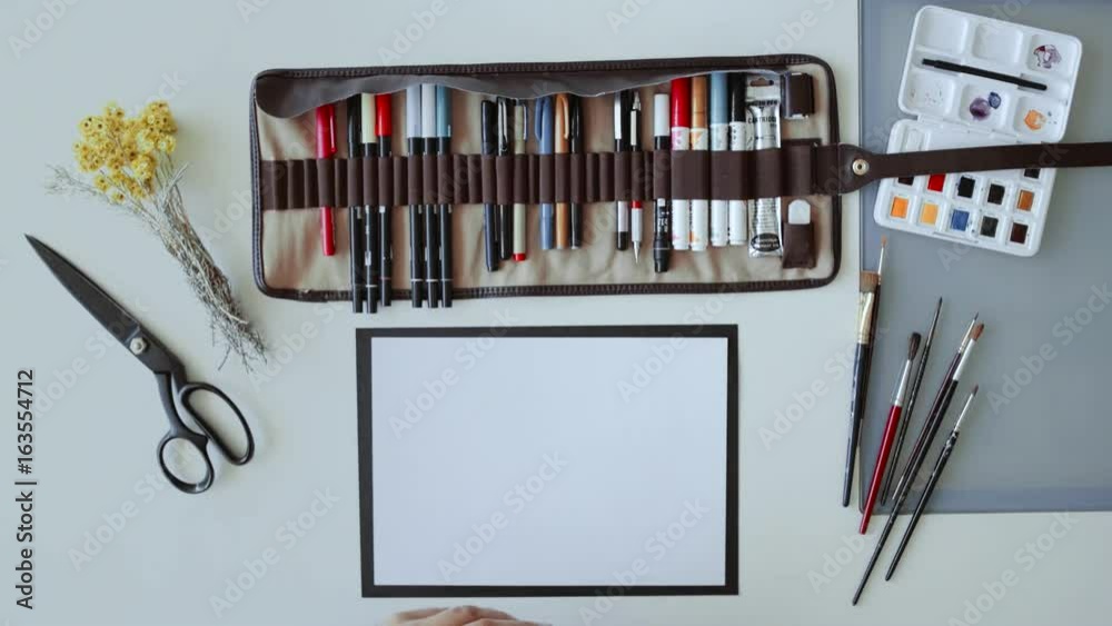 Overhead shot of hand lettering artist in home studio working on ...