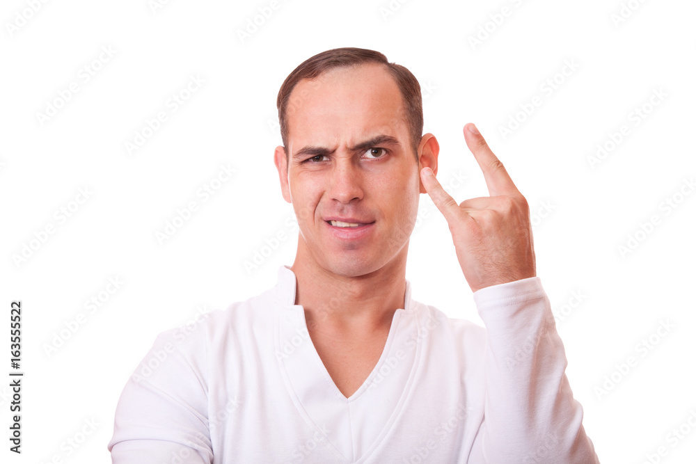 portrait of a young man in white background showing a sign of rock and roll portrait of a young man in white background showing a sign of rock and roll