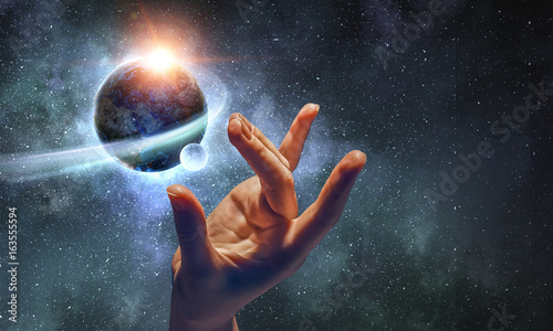 Touching planet with finger photo