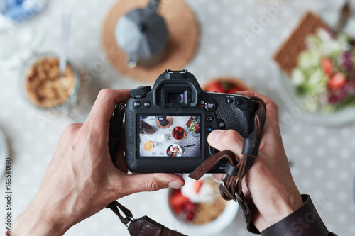 Professional food-photographer making shot of food for advert photo