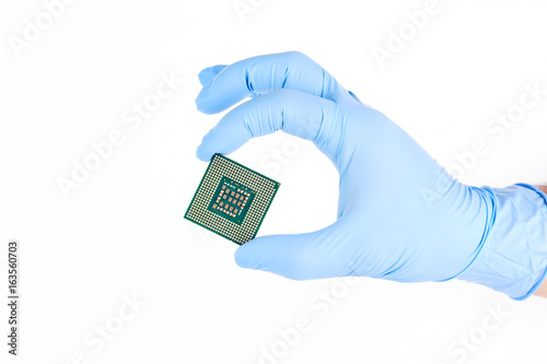 Hand With Glove Holding Small Powerful Computer Processor Isolated On White Background