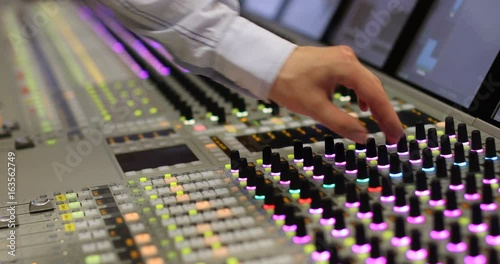 Hands of Audio engineer working. Professional audio mixer, sound engineer, producer control engineer, audio mixing console photo