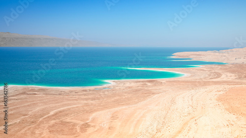 Dead Sea salt lake surface shore and beach