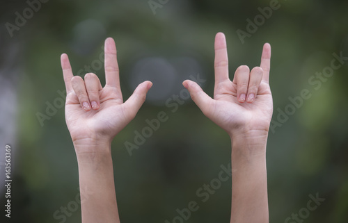 young woman love hands sign © NAMPIX